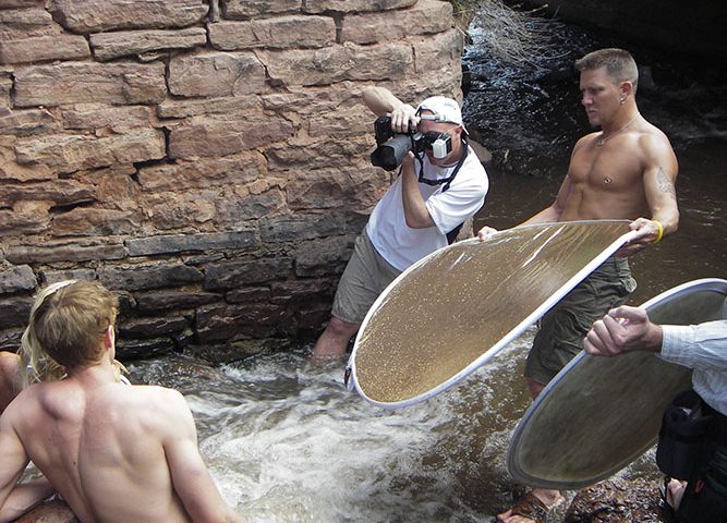 Brody Hall photographing two models in Tennessee stream