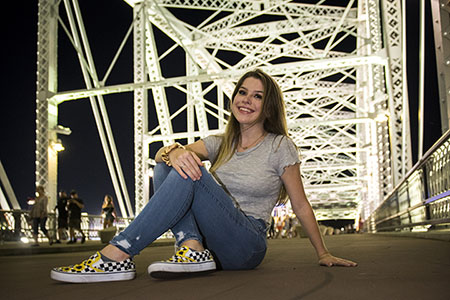 Young woman sitting on Pedestrain bridge in downtown Nashville, TN Young woman sitting on Pedestrain bridge in downtown Nashville, TN