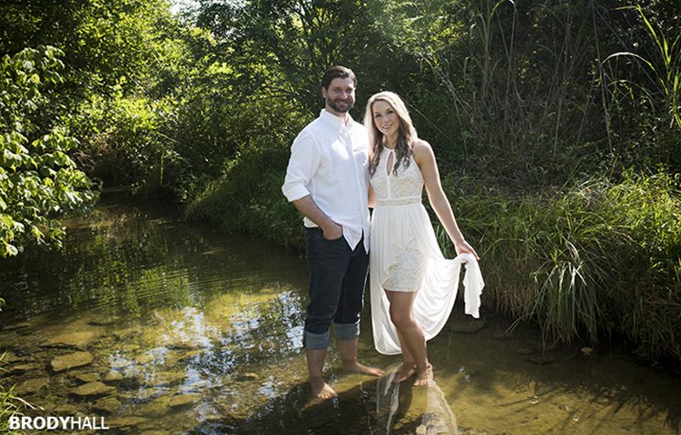 Engaged couple standing in a clear calm creek just outside of Nashville.