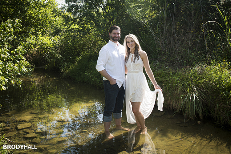 Engaged couple standing in a clear calm creek just outside of Nashville.