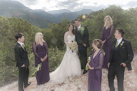 Bridal party posing on a rock Bridal party posing on large boulders in Colorado