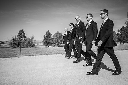 Grroomsmen walking down the road Tuxedo dressed groomsmen walking down a dirt road in Colorado