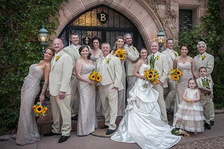 Bridal party posing by the Briarhurst in Colorado Springs Bridal party posing in front of a large arched door in Tennessee