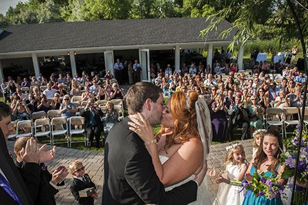 The wedding kiss A couple wedding kiss with all the guest in the background taken at Ralston's Crossing, Colorado