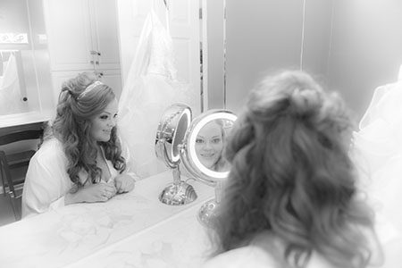 Bride getting ready looking in mirror Bride getting ready and looking in mirror in Nashville