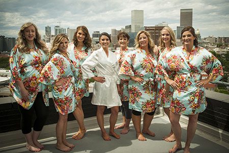 Bride and brides maids in robes - posing on rooftop Bride and bride's maids in robes, posing on rooftop in Denver