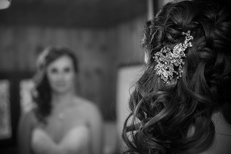Bridal hair brooch with bride looking in mirror Bridal hair brooch with bride looking in mirror