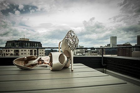 Brides shoes Bride's shoes on a table with downtown Denver in the background.