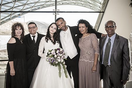 Bride & Groom and parents Bridal couple posing with parents at the Denver Airport