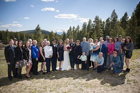 Family photo of bride and groom and family Bridal party and family posing on a mountain side in Copper, Colorado