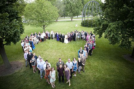 Wedding guest in the shape of a heart overhead shot of a huge heart on a grassy field formed from the wedding guests in Chicago