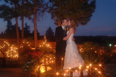 The kiss evening photo of Bride & Groom kissing with candles all around in Colorado