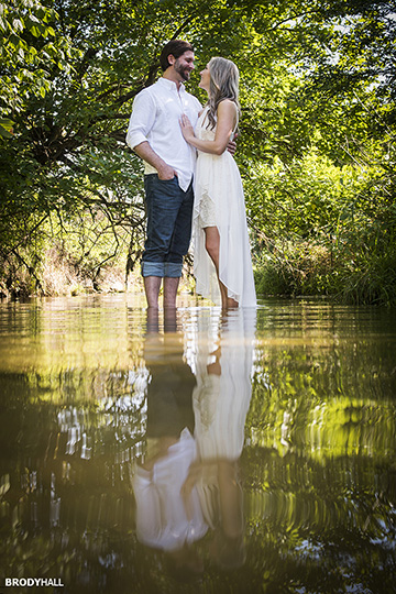 Engagement photo of couple standing in a Nashville stream looking at each other