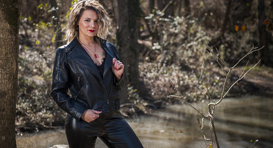 female client in leather jacket and pants in woods in Tennessee