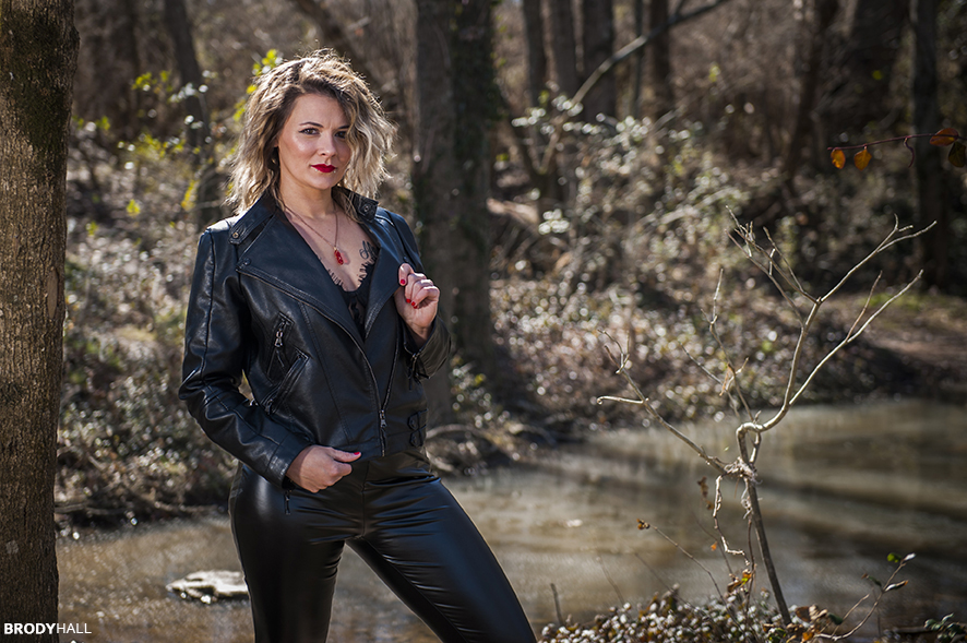 female client in leather jacket and pants in woods in Tennessee