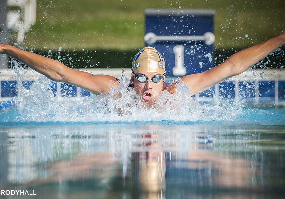 Senior photo of student doing the butterfly stroke in pool in Hendersonville, TN