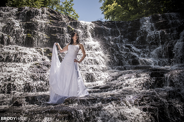 bride in wedding dress, standing in Rutledge falls