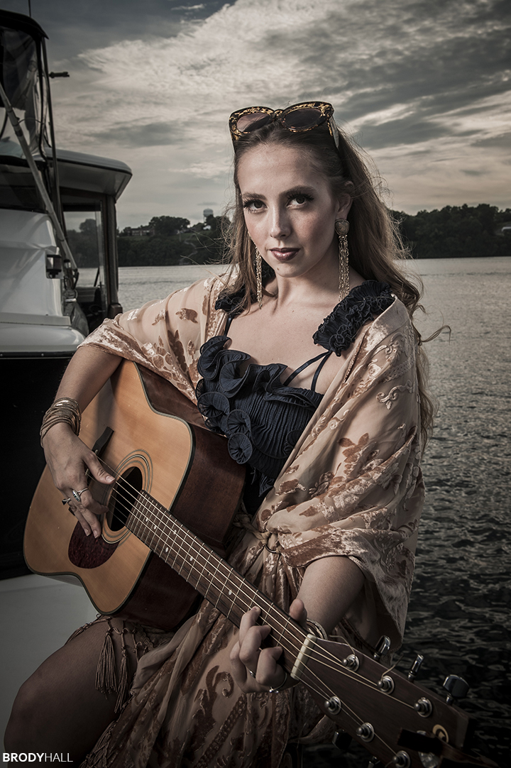 Angela playing a guitar on a boat Woman playing a guitar on a boat in Tennessee
