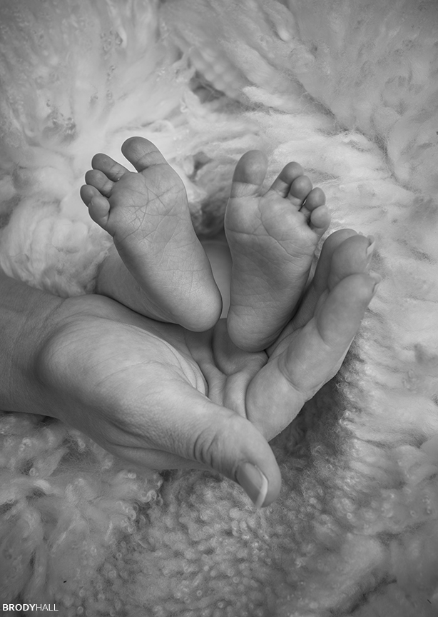 Baby Steps Black and white image of Baby's feet being held by mother's hands.