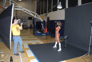 01-bts-cheerleader-shoot-05 Taking a photo of a Denver Cheerleader in a training gym with a portable studio set-up.